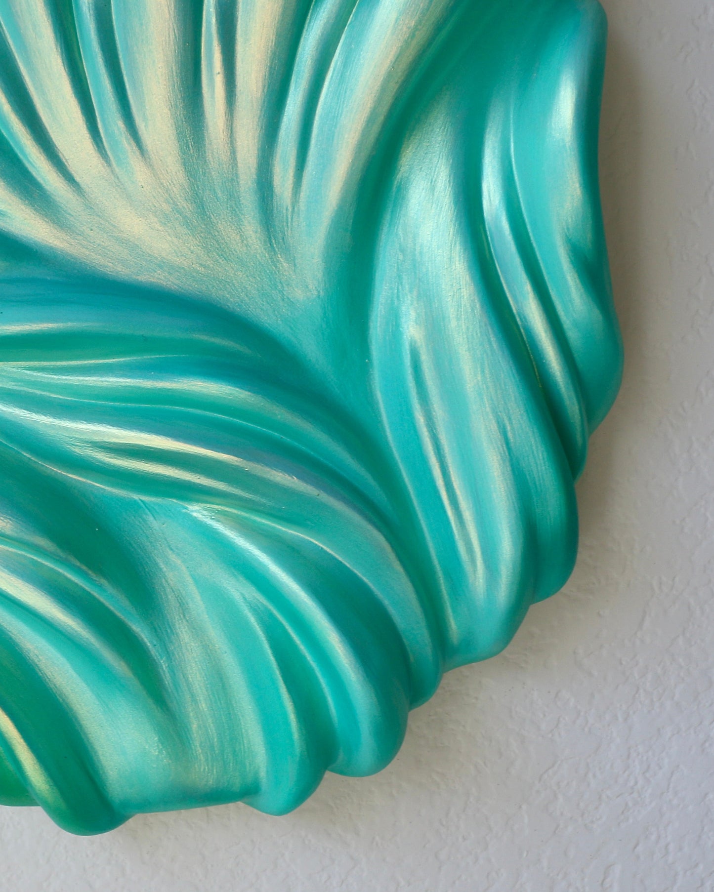 Turquoise and white decorative shell on a light gray background