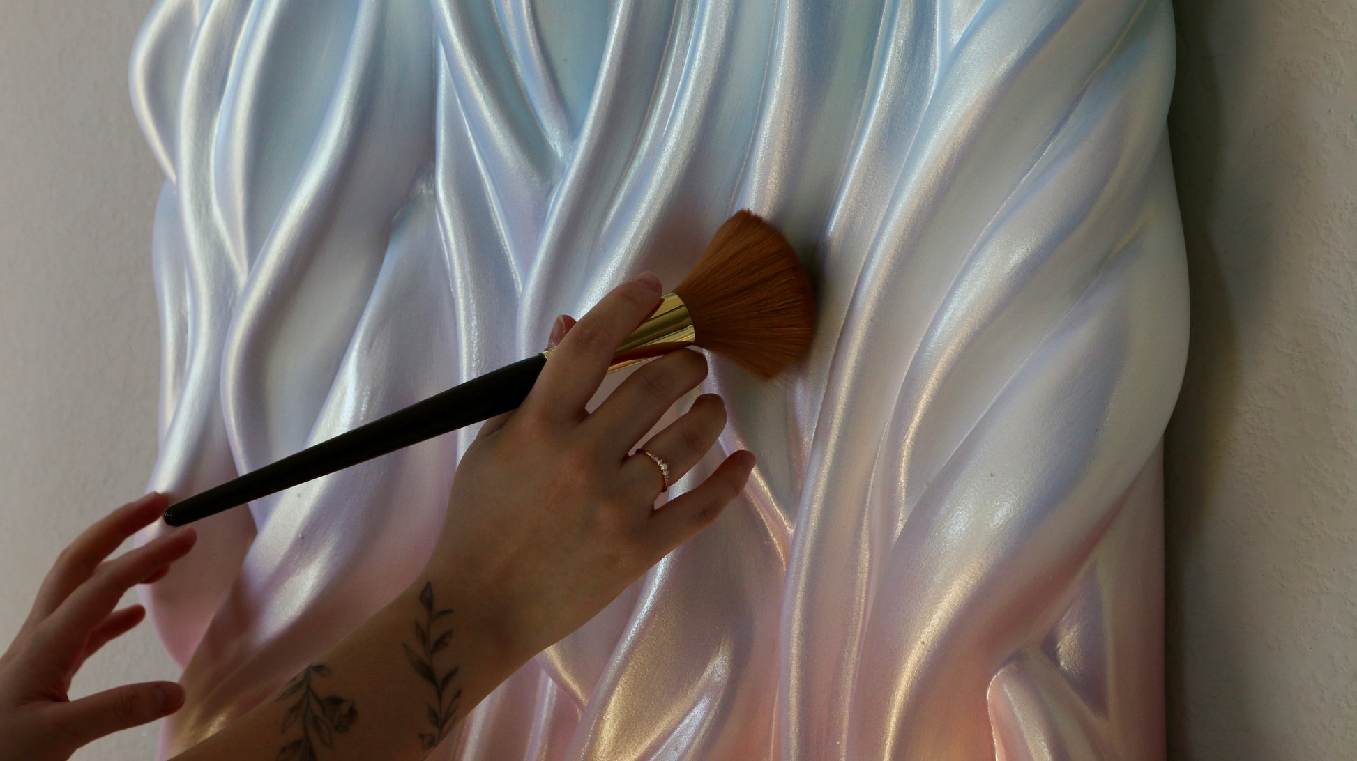 Person painting a textured wall with a brush